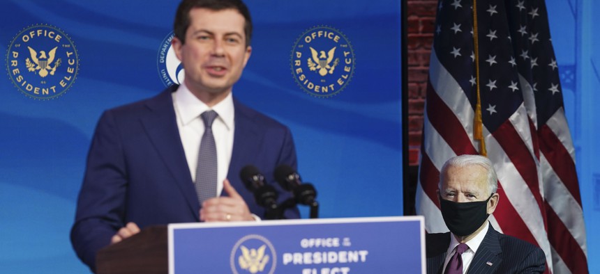 Pete Buttigieg, President-elect Joe Biden's nominee to be transportation secretary, speaks as Biden looks on during a news conference at The Queen theater in Wilmington in December.