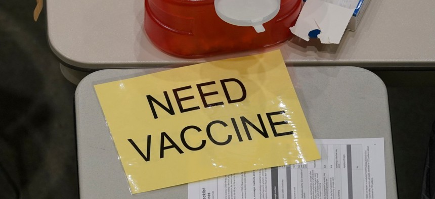 A sign signals workers to bring more doses of the Pfizer vaccine for COVID-19 to medical personnel at a one-day at a clinic in Seattle on January 24.