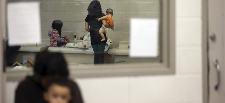 Detainees wait in a holding cell at a U.S. Customs and Border Protection processing facility in 2014 in Brownsville,Texas.