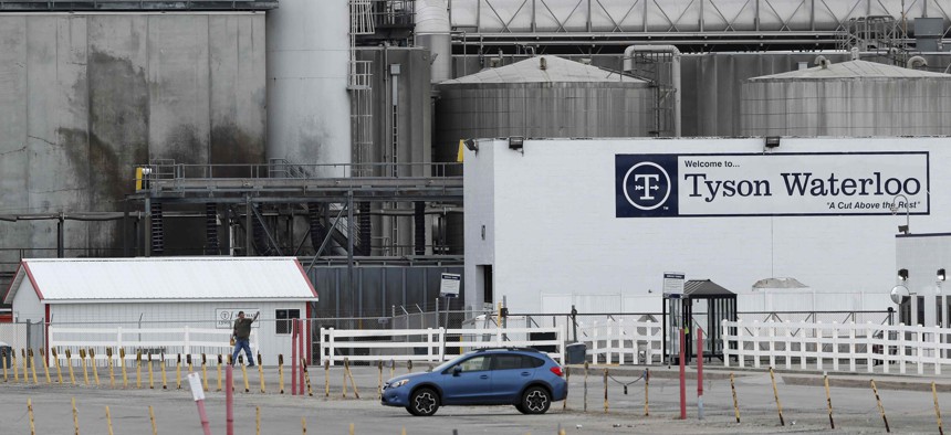 In this Friday, May 1, 2020, photo, a worker leaves the Tyson Foods plant in Waterloo, Iowa.