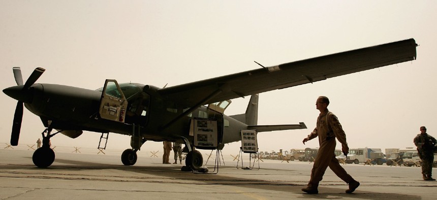 Iraqi air force members and their U.S trainers are seen near the Iraqi air force Caravan (Cessna 280) Intelligence, Surveillance and Reconnaissance (ISR) aircraft on July 30, 2008 at the New Al Muthana Air Base in Baghdad, Iraq. 