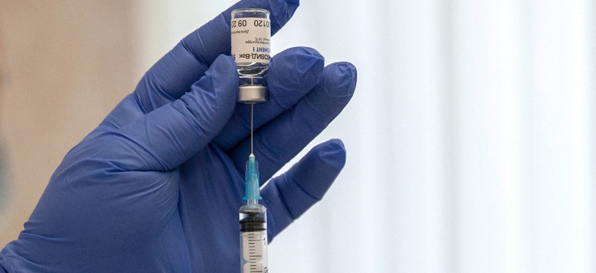 A Russian medical worker prepares a shot of Russia's Sputnik V coronavirus vaccine in Moscow on Dec. 10. 