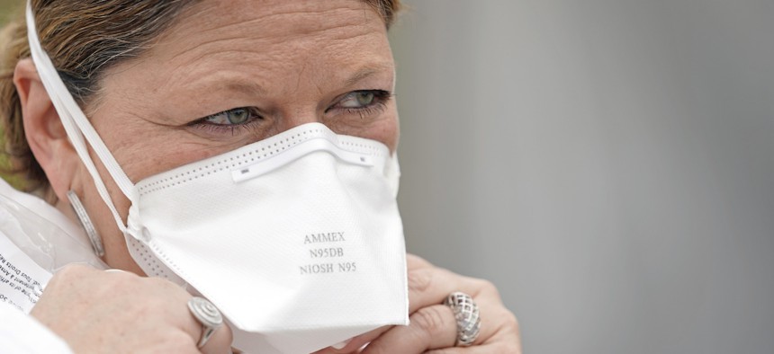 Nurse Yvette Laugere adjusts her N95 mask while working at a newly opened free COVID-19 testing site operated by United Memorial Medical Center on April 2 in Houston