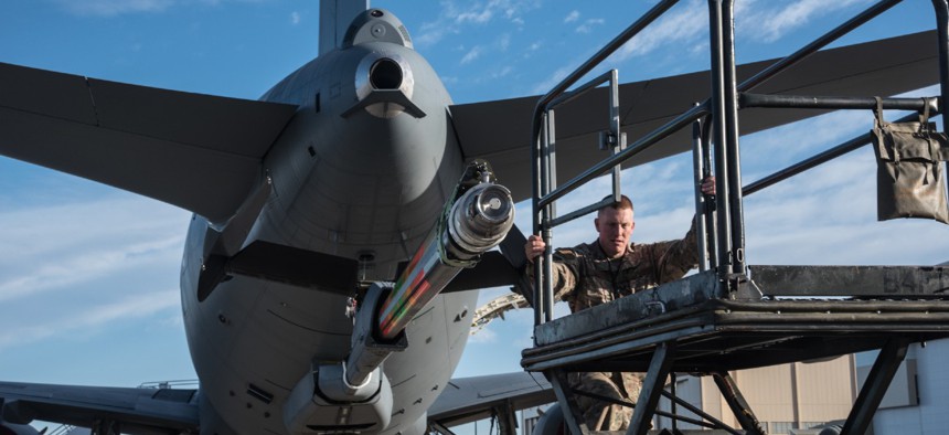 Master Sgt. Chris Hughes, 22nd Maintenance Squadron hydraulics craftsman, climbs onto a B4 stand to begin an acceptance inspection on a KC-46A Pegasus boom in February 2019 at McConnell Air Force Base, Kan. 