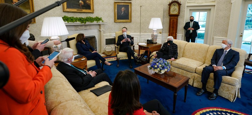 President Joe Biden, accompanied by Vice President Kamala Harris and Treasury Secretary Janet Yellen, meets with business leaders to discuss a coronavirus relief package in the Oval Office on Feb. 9.