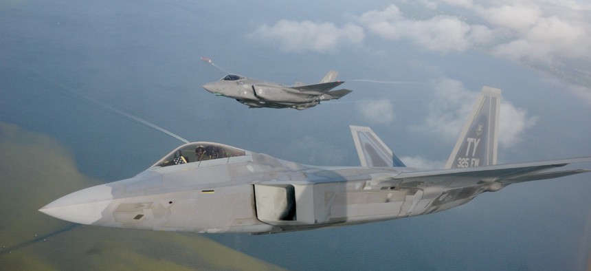 An F-22 Raptor from the 325th Fighter Wing flies alongside an F-35 Lightning II from the 33rd Fighter Wing over the Emerald Coast. 