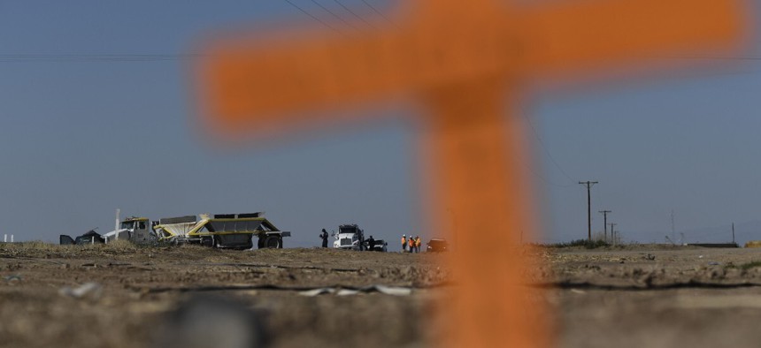Crosses are seen near the scene of a crash between an SUV and a semi-truck full of gravel near Holtville, California on March 2, 2021