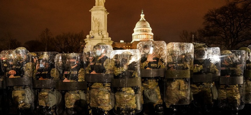 District of Columbia National Guard stand outside the Capitol on Jan. 6 after a day of rioting protesters. The poll also found an increasing number of Americans are more concerned about internal threats to the United States, such as domestic terrorism.