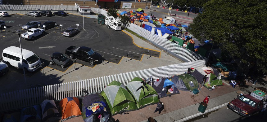 Tents used by migrants seeking asylum in the United States line an entrance to the border crossing on March 1, in Tijuana, Mexico.
