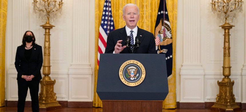 President Joe Biden speaks about COVID-19 vaccinations, from the East Room of the White House on March 18 as Vice President Kamala Harris listens.