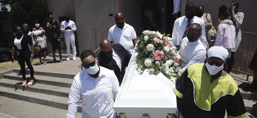 Pall bearers carry a casket with the body of Lydia Nunez, who died from COVID-19, after a funeral service at the Metropolitan Baptist Church in Los Angeles in Jully