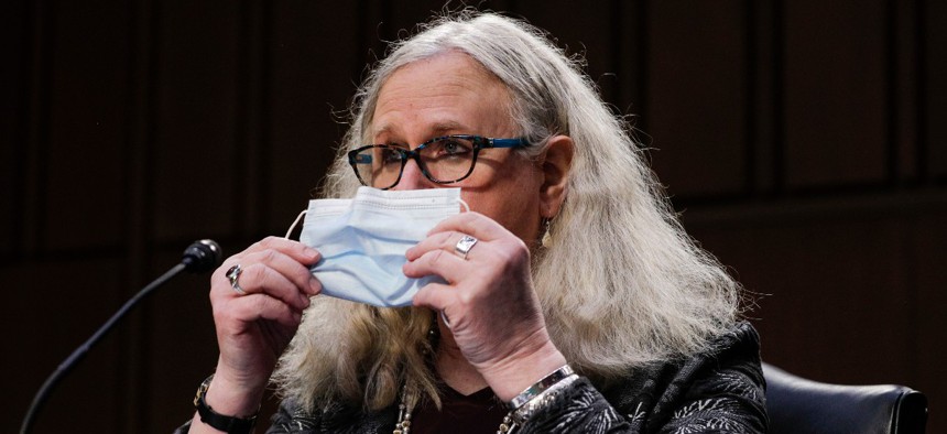 Rachel Levine, nominated to be an assistant secretary at the Department of Health and Human Services, holds her face mask as she testifies on Capitol Hill in February.