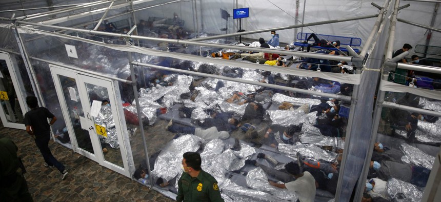 Unaccompanied minors lie inside a pod at a Department of Homeland Security holding facility in Donna, Texas, the main detention center for unaccompanied children in the Rio Grande Valley. The minors are housed by the hundreds in eight pods of about 3,200.