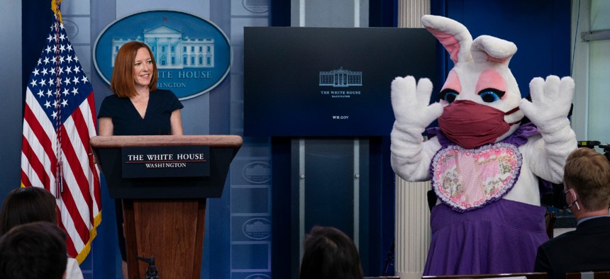 White House press secretary Jen Psaki smiles at the Easter Bunny during a press briefing at the White House on Monday. 