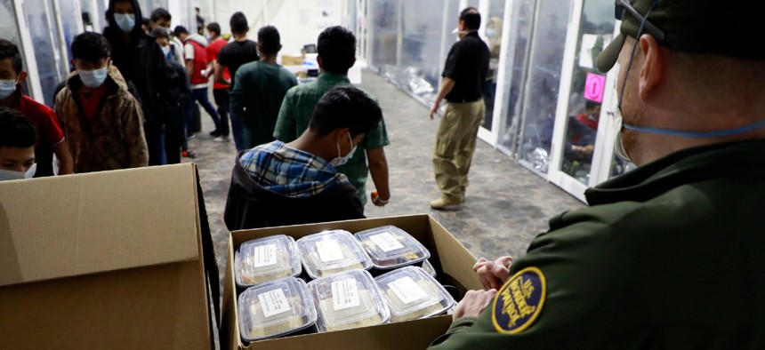 A Border Patrol agent works at a temporary processing facility in Donna, Texas, in March.