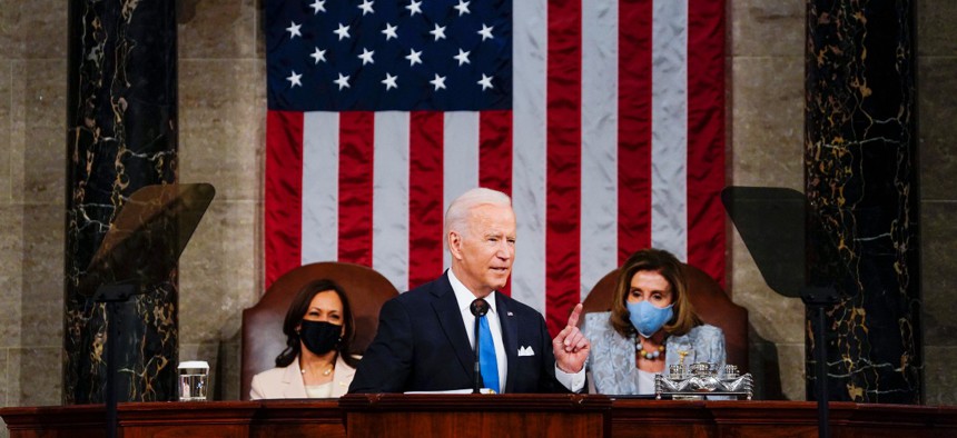 President Joe Biden addresses a joint session of Congress on April 28 as Vice President Kamala Harris, left, and House Speaker Nancy Pelosi of Calif., look on.