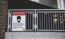 A sign outside the metro station at Mt Vernon Square 7th St-Convention Center informs riders that face coverings are required in the station and on trains.