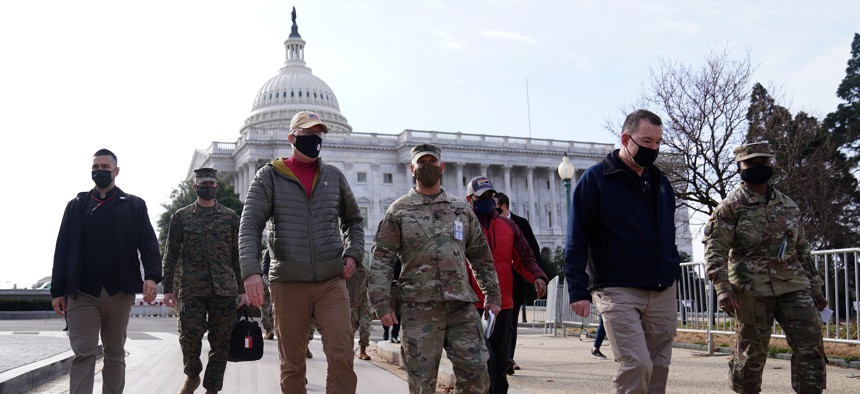Acting Secretary of Defense Christopher Miller (third from left) walks with members of the National Guard outside the U.S. Capitol on January 17, 2021, in Washington, DC. 