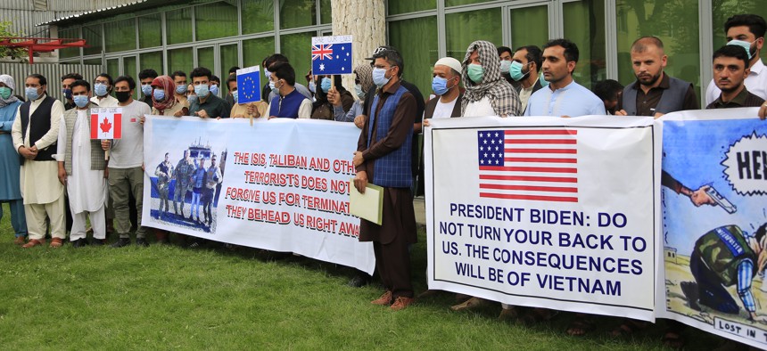 Former Afghan interpreters hold placards during a protest against the U.S. government and NATO in Kabul, Afghanistan, on April 30.