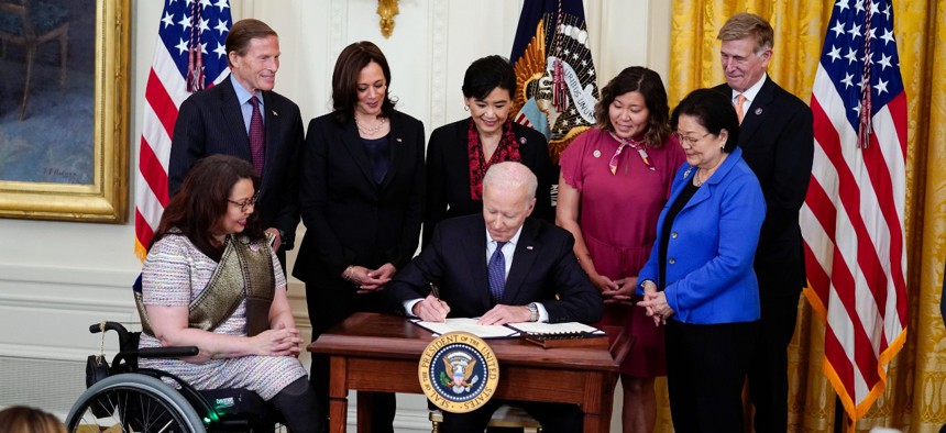 President Joe Biden signs the COVID-19 Hate Crimes Act in the East Room of the White House on May 20. Credit: