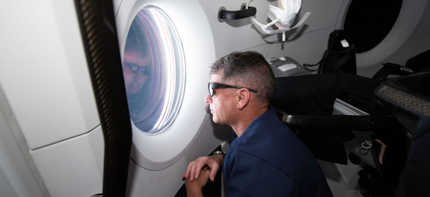 NASA astronaut and SpaceX Crew-2 Commander Shane Kimbrough, looks out the Crew Dragon Endeavour's window during its trip to the International Space Station.
