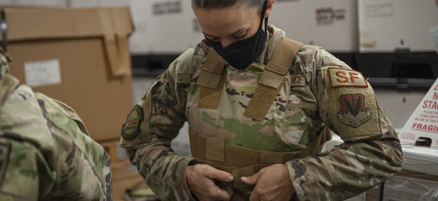 Tech. Sgt. Emily Souza, 23d Security Forces Squadron NCO in charge of combat arms, adjusts body armor Nov. 20, 2020, at Moody Air Force Base, Georgia.