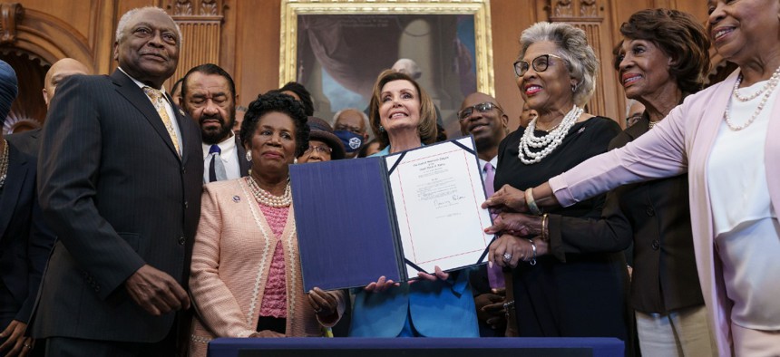 From left, Majority Whip James Clyburn, D-S.C., Rep. Al Green, D-Texas, Rep. Sheila Jackson Lee, D-Texas, Speaker of the House Nancy Pelosi, D-Calif., Rep. Joyce Beatty, D-Ohio, Rep. Maxine Waters, D-Calif., Rep. Barbara Lee, D-Calif., and members of the Congressional Black Caucus celebrate the passage of the Juneteenth National Independence Day Act that creates a new federal holiday to commemorate June 19, 1865.