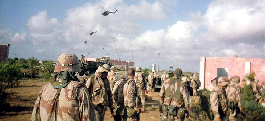 Army soldiers of Company B, 2nd Battalion, 14th Infantry Regiment, watch helicopter activity over Mogadishu, Oct. 3, 1993. Later the same day and throughout the night, the battalion's A and C Companies were part of a rescue convoy assembled for nearly 100 Rangers who had become trapped in the city after two Black Hawks were shot down.
