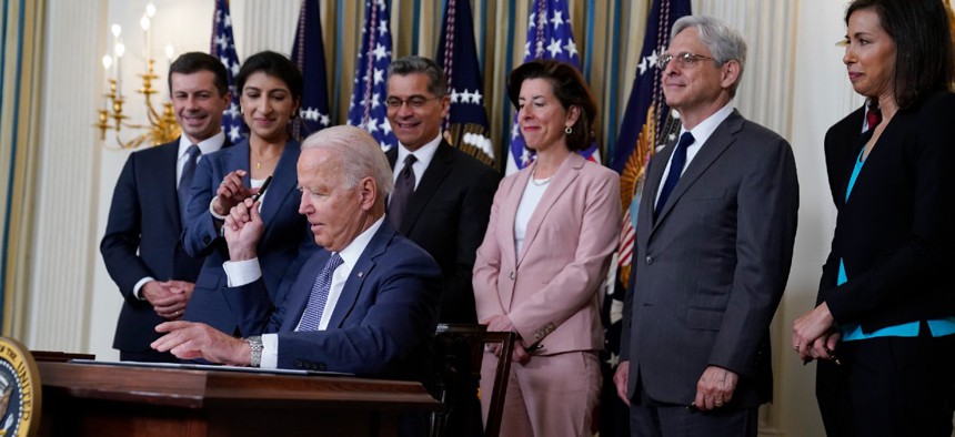 President Biden signs an executive order aimed at promoting competition in the economy in the State Dining Room of the White House on July 9.