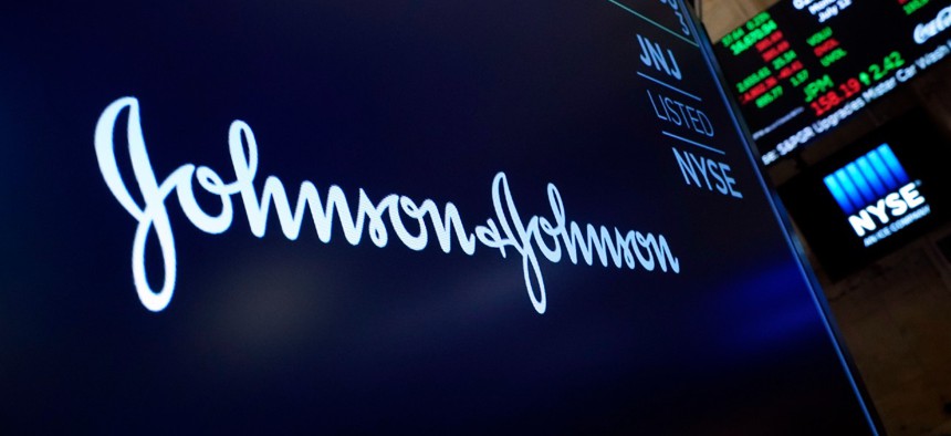 The Johnson & Johnson logo appears above a trading post on the floor of the New York Stock Exchange. Johnson & Johnson's COVID-19 vaccine may pose a "small possible risk" of a rare but potentially dangerous neurological reaction, U.S. health officials said Monday. 