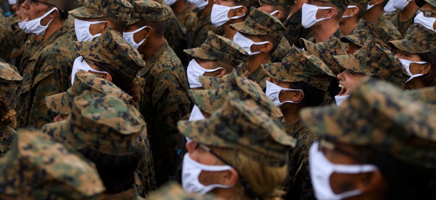 United States Marine Corps recruits wear face masks as they sing The Marines' Hymn on April 22, 2021, at Camp Pendleton, California. 