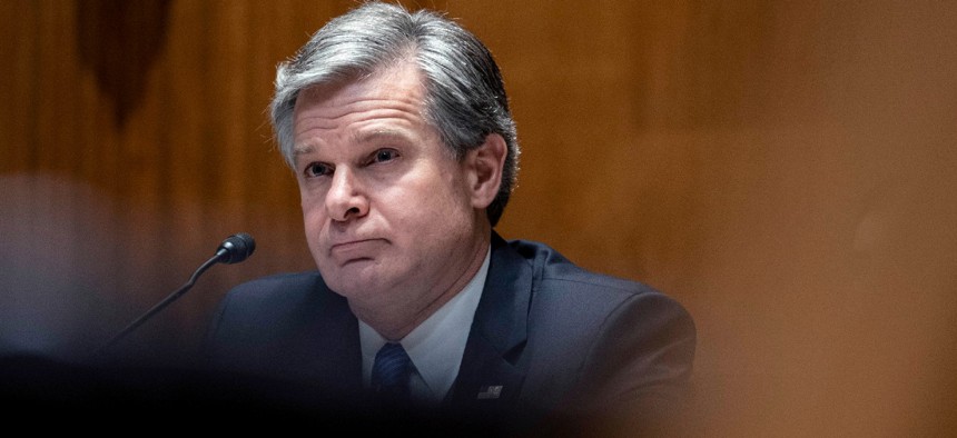 FBI Director Christopher Wray testifies on Capitol Hill in June. 