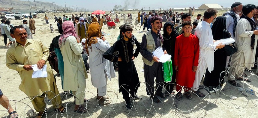 Hundreds of people gather outside the international airport in Kabul, Afghanistan, Tuesday, Aug. 17, 2021.
