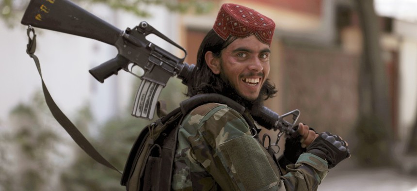 A Taliban fighter patrols in Wazir Akbar Khan in the city of Kabul, Afghanistan, Wednesday, Aug. 18, 2021.