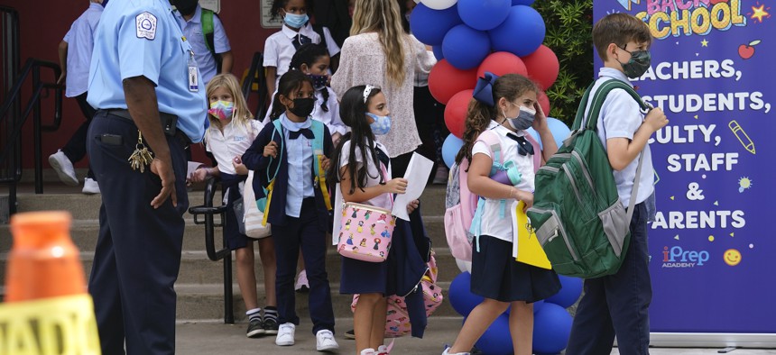 Students walk from iPrep Academy on the first day of school, Monday, Aug. 23, 2021, in Miami. 