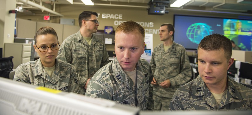 Airmen of the Joint Space Operations Center monitor computer systems designed to detect, track, and identify all artificial objects in Earth's orbit at Vandenberg Air Force Base, Calif., in 2014.