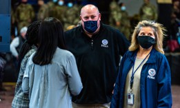 FEMA's Bob Fenton tours a COVID-19 vaccination site in New York in February. Fenton has been tapped to lead the effort to bring more than 100,000 Afghans into the United States.
