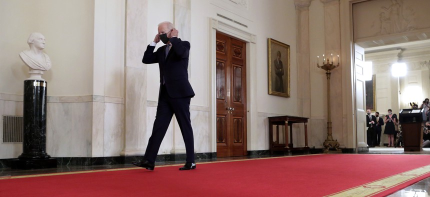 U.S. President Joe Biden replaces his face mask after delivering remarks on the end of the war in Afghanistan in the State Dining Room at the White House on August 31, 2021.