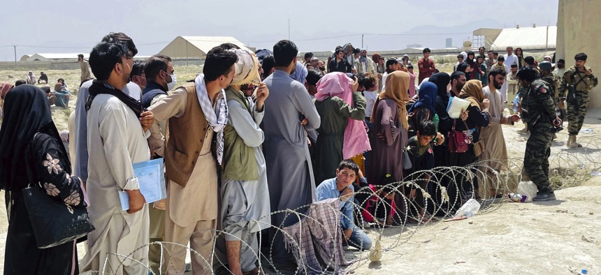Hundreds of people who want to flee the country gathered outside the international airport in Kabul, Afghanistan, Aug. 17, 2021.