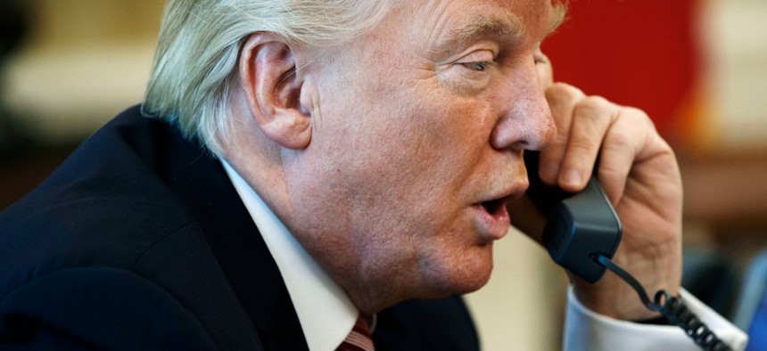 President Trump talks on the telephone in the Oval Office of the White House in June 2017. 