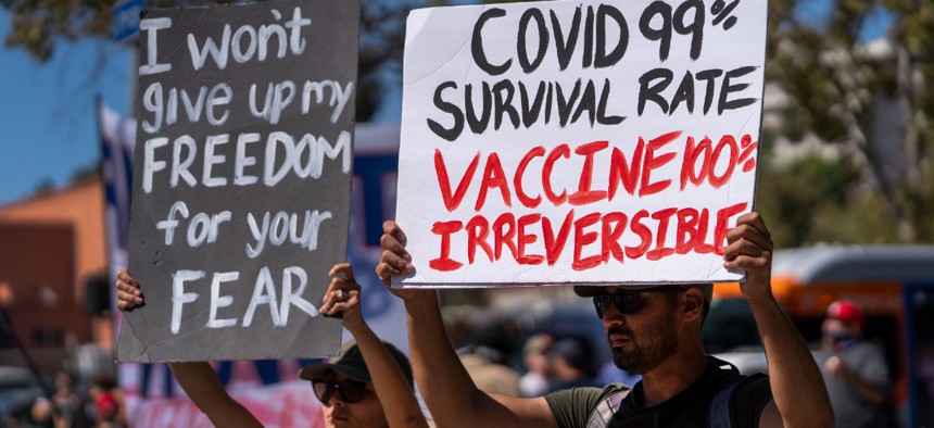 Protesters opposing COVID-19 vaccine mandates hold a rally in front of City Hall in downtown Los Angeles. 