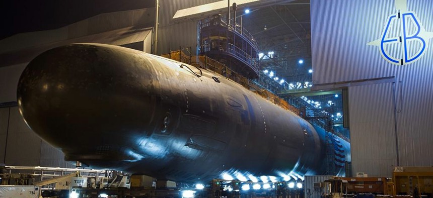 The Virginia-class attack submarine North Dakota (SSN 784) is rolled out of an indoor shipyard facility at General Dynamics Electric Boat in Groton, Connecticut.