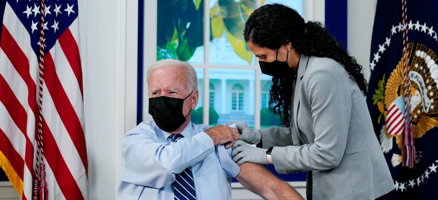 President Biden receives a COVID-19 booster shot during an event in the South Court Auditorium on the White House campus on Monday.