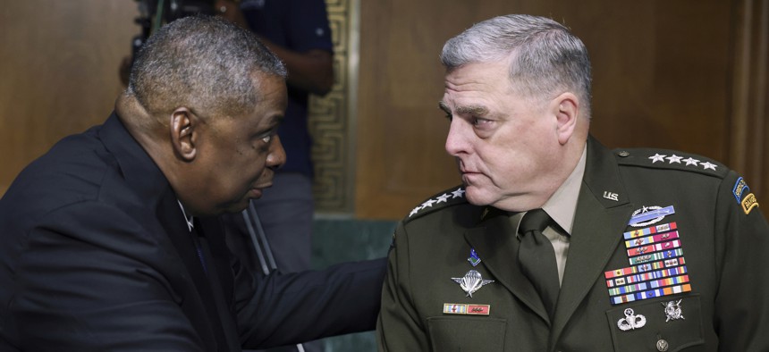 Secretary of Defense Lloyd Austin, left, and Chairman of the Joint Chiefs Chairman Gen. Mark Milley talk during a Senate hearing on June 17, 2021.