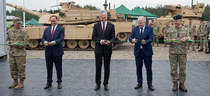 Lithuanian Minister of National Defense Arvydas Anušauskas, second from right, and Lt. Col. Paul Godson, commander of the U.S. Army's 3rd Battalion, 66th Armored Regiment, at a recent ribbon-cutting ceremony for Lithuania's Camp Herkus.