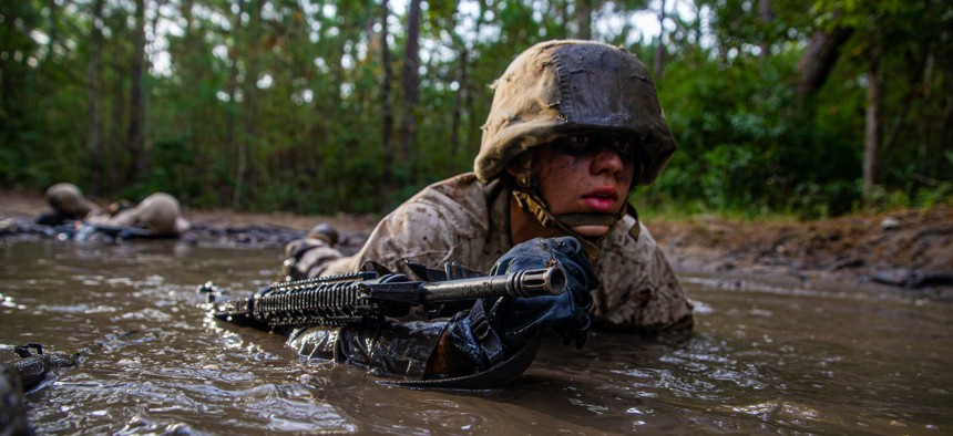 A recruit with Papa Company, 4th Recruit Training Battalion, low crawls during the Crucible on Marine Corps Recruit Depot Parris Island, S.C. Oct. 22, 2021.