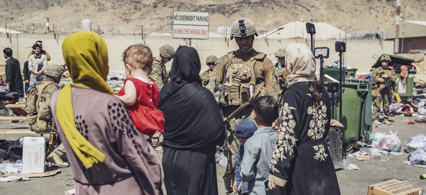 U.S. Marines with the 24th Marine Expeditionary Unit process evacuees as they go through the Evacuation Control Center during an evacuation at Hamid Karzai International Airport, Kabul, Afghanistan, Aug. 28. 