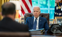 President Biden meets with White House staff in the Oval Office of the White House in August.