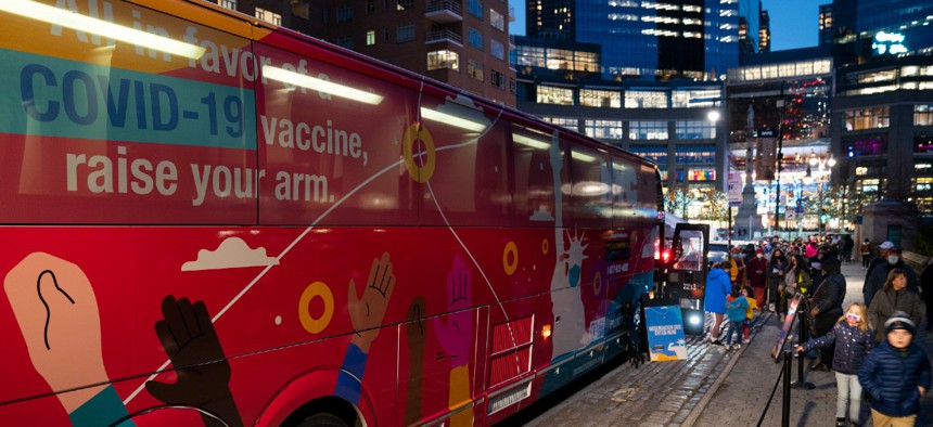 Patients wait to receive a COVID-19 vaccine booster shot at a mobile vaccination station on 59th Street below Central Park in New York City on Dec. 2. 
