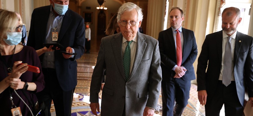 Senate Minority Leader Mitch McConnell walks with staff to the office of Senate Majority Leader Chuck Schumer on Capitol Hill. 